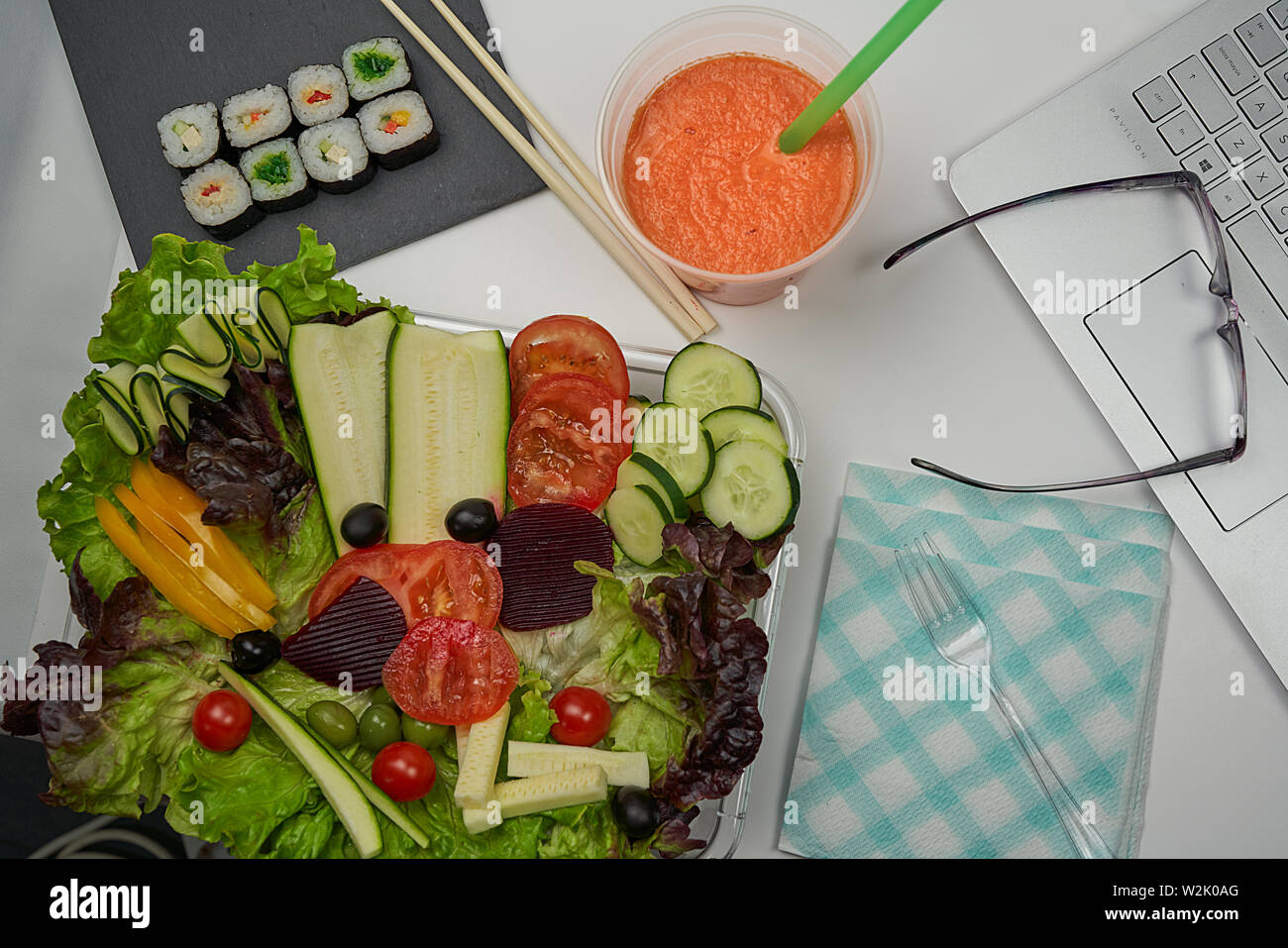 Ensalada de lechuga, calabacín, tomate, aceitunas negras, pimiento  amarillo. De zanahoria, piña y melocotón batido. pequeños bocados de sushi  Fotografía de stock - Alamy