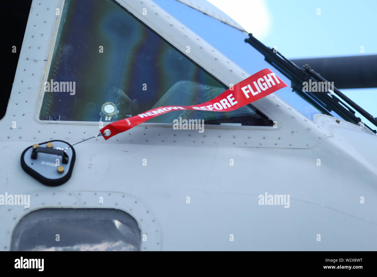 Retirar antes de la advertencia de seguridad de vuelo con cinta en el parabrisas de un avión de carga militar Foto de stock