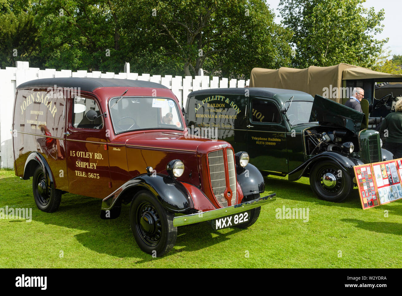 2 restaurado Jowett Bradford camionetas (rojo y verde oscuro) limpio brillante exhibe estacionada en pantalla - Vehículo clásico show, Burley en Wharfedale, Inglaterra, Reino Unido. Foto de stock