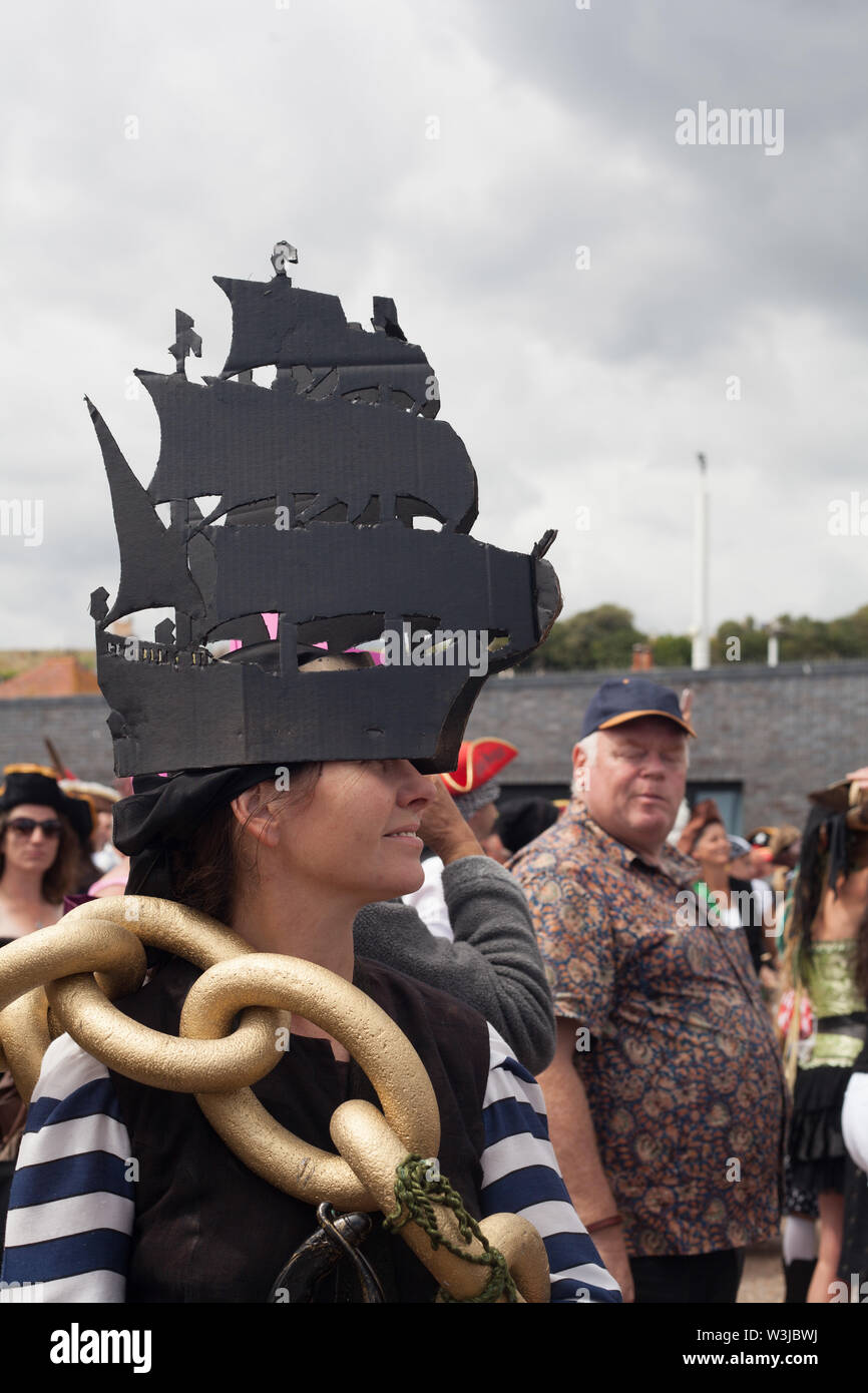 Mujeres vistiendo un sombrero negro diseñada en forma de barco de vela  hecha de cartón, el día de la Jerga Pirata en julio, Hastings, East Sussex,  Reino Unido Fotografía de stock -