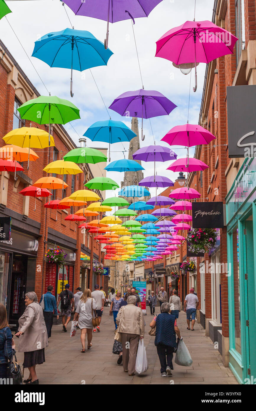 Una colorida exhibición de paraguas colgando el techo de la zona comercial en Reino Unido Fotografía de - Alamy