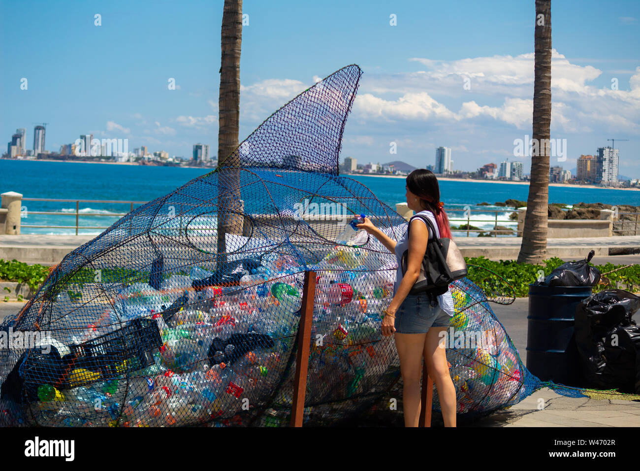 https://c8.alamy.com/compes/w4702r/de-tez-blanca-mujer-turista-hispano-depositar-la-botella-de-plastico-en-la-papelera-especial-para-reciclar-plasticos-w4702r.jpg