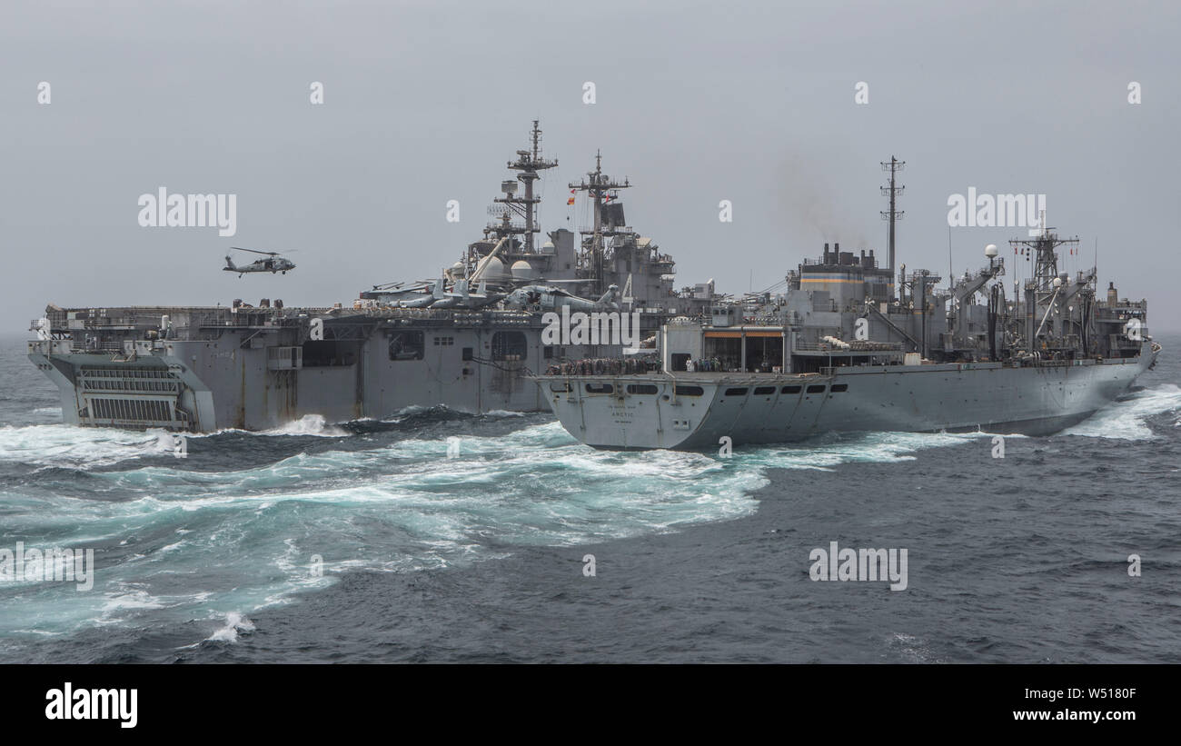 190714-M-QS181-1004 Mar Arábigo (14 de julio de 2019) el buque de asalto anfibio USS Boxer (LHD 4) (izquierda), recibe los suministros desde el Ártico USNS (T-AOE-8) durante un reabastecimiento en alta mar. El boxeador Amphibious Ready Group y la 11ª MEU se despliegan en los EE.UU. 5ª Flota de la zona de operaciones en apoyo de las operaciones navales para garantizar la estabilidad y la seguridad marítima en la Región Central, que conecta el Mediterráneo y el Pacífico a través del Océano Índico occidental y tres estratégicos puntos críticos. (Ee.Uu. Marine Corps foto por CPL. Jason Monty) Foto de stock