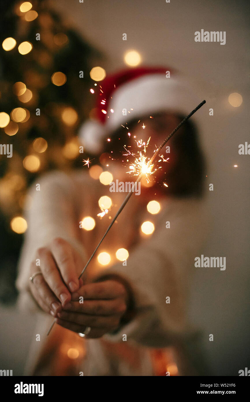velas de bengalas brillantes de navidad se queman en el fondo del árbol de  navidad. decoración de iluminación navideña en el interior de la casa.  luces de chispas mágicas festivas para fiestas