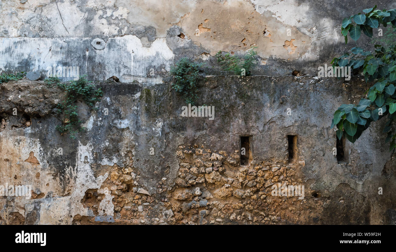 Tiempo gastado en la pared de un edificio en la Ciudad de Piedra de Zanzíbar. Foto de stock