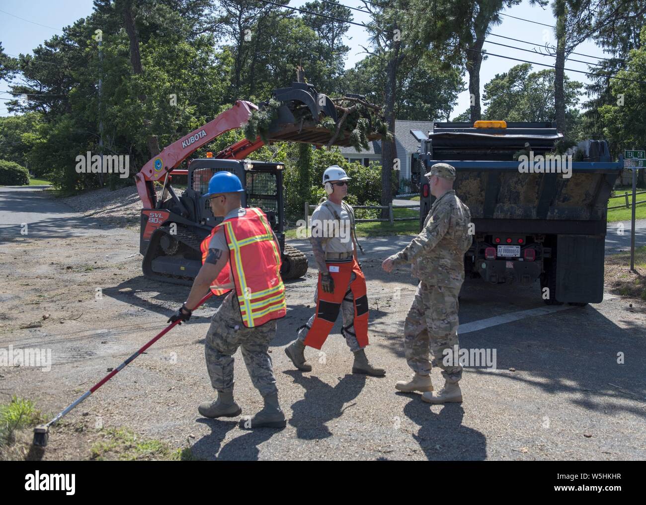 Aviadores de la Guardia Nacional Aérea de Massachusetts 102º Escuadrón de Ingenieros Civiles movilizados para apoyar los esfuerzos de recuperación a raíz de dos tornados que tocó en Cape Cod el 23 de julio de 2019, 25 de julio de 2019. Los aviadores borra los árboles caídos y escombros de carreteras en los municipios de Dennis y Harwich, Massachusetts. Imagen cortesía de Tech. El Sgt. Thomas Swanson/102ª Ala de inteligencia. () Foto de stock