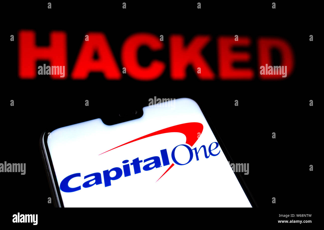 Capital One Bank logo en el smartphone y alerta roja en el hackeado word fondo difuminado. Foto conceptual para la fuga de datos. Foto de stock