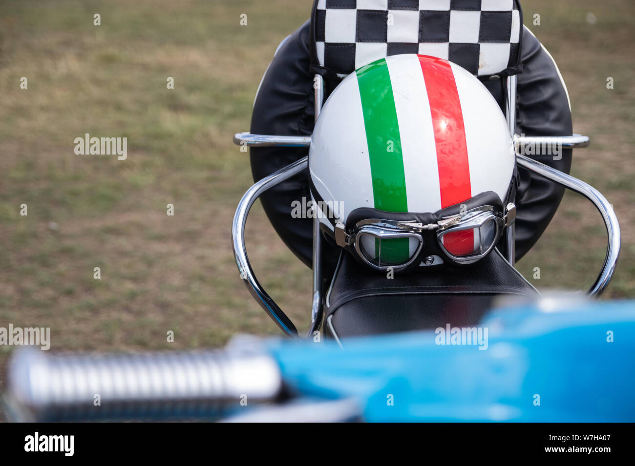 Un scooter o ciclomotor del casco en el asiento de un scooter vintage Foto de stock