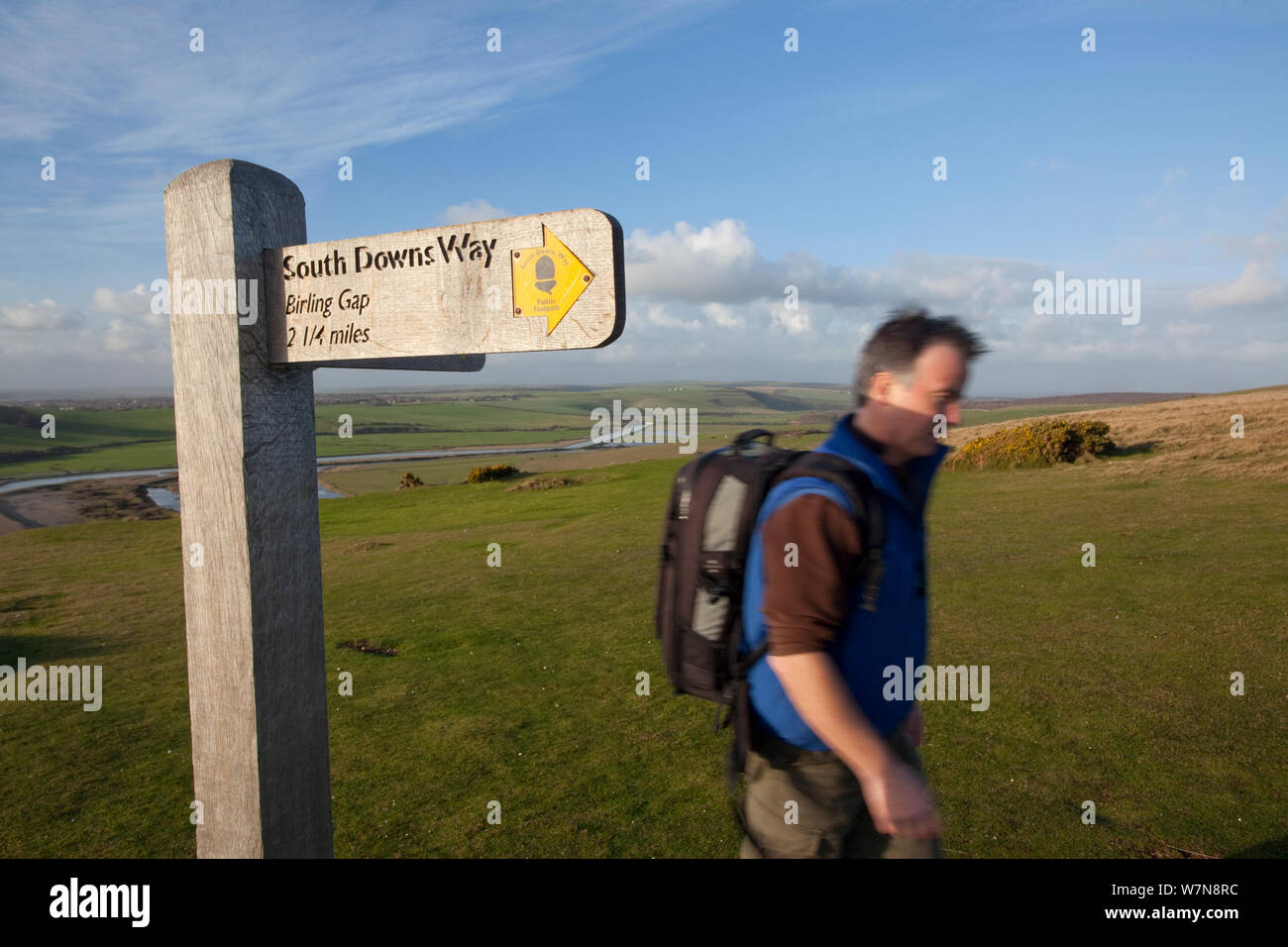 Hombre caminando pasado South Downs camino sendero de larga distancia