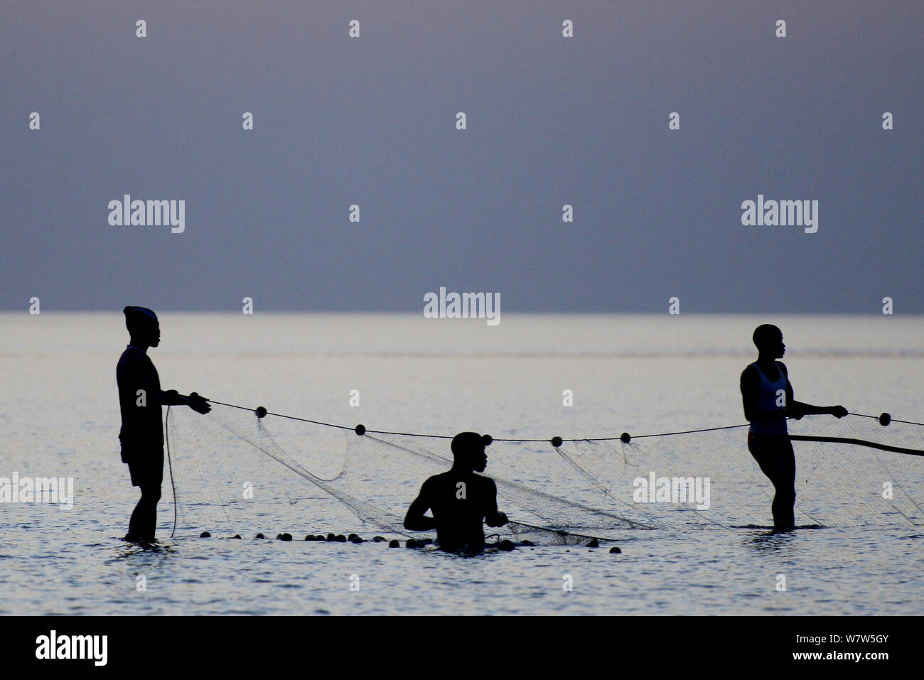 Los pescadores con net en marea baja, Isla de Orango, Guinea-Bissau, diciembre de 2013. Foto de stock