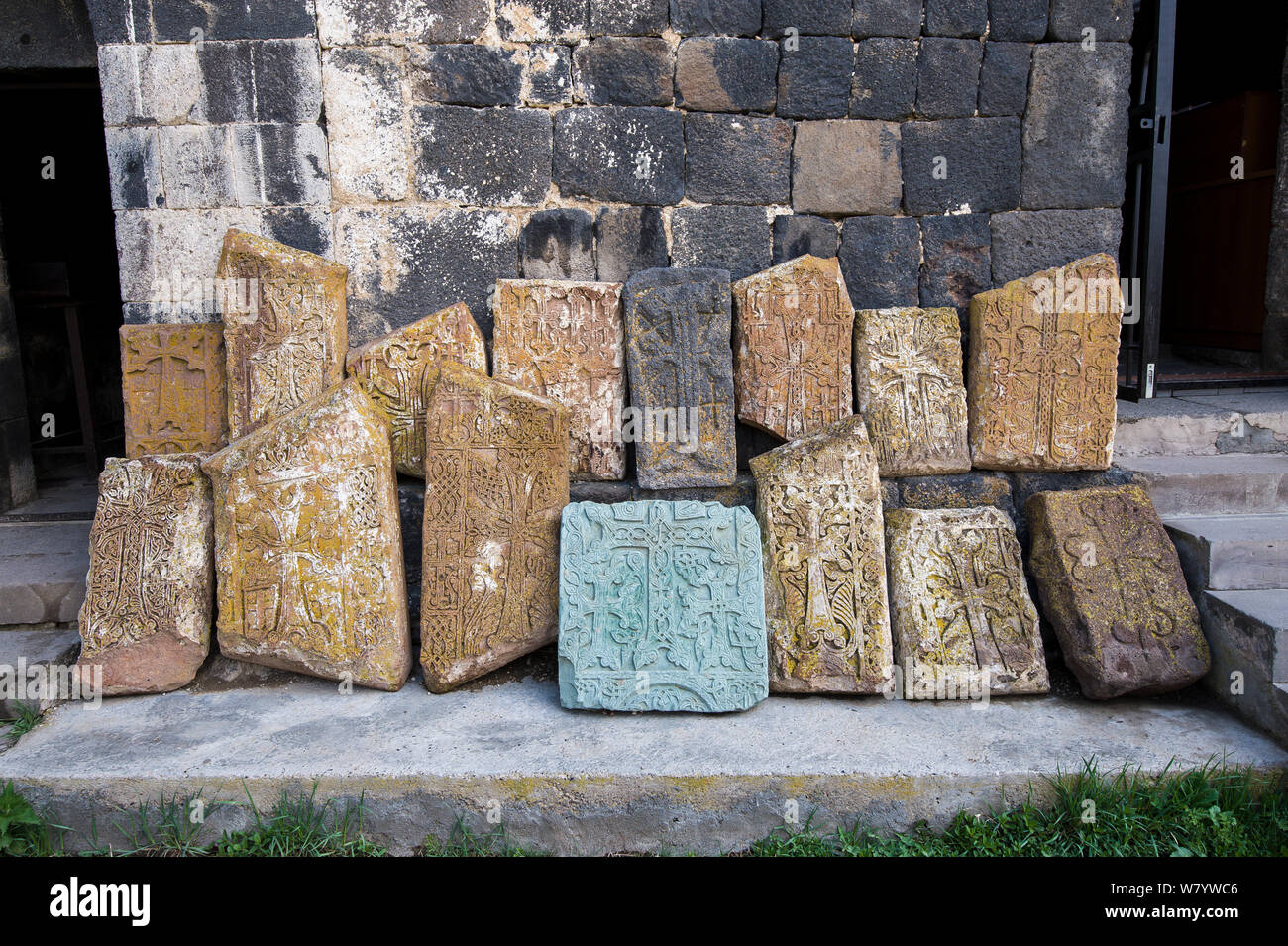 Cross-piedras (khachkars) colocados a lo largo de la pared de la Iglesia armenia, Mayo. Foto de stock
