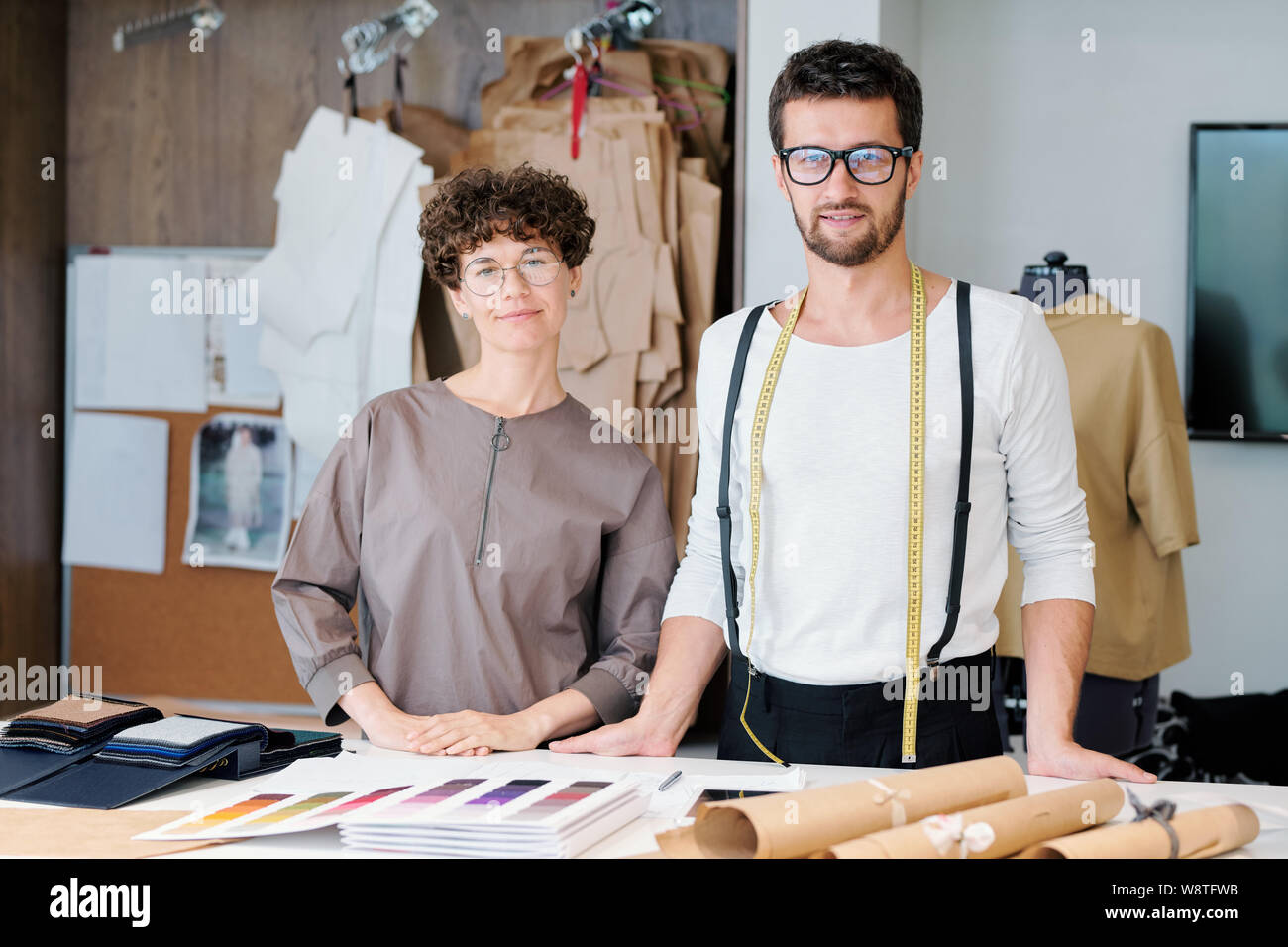 Dos jóvenes seguros de diseñadores de moda nueva colección haciendo su trabajo habitual Foto de stock