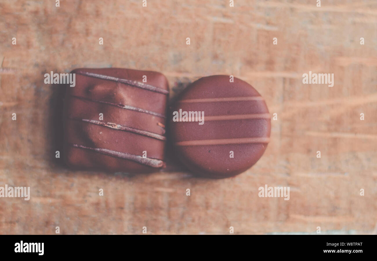 Bono de chocolate de lujo hecho a mano. Primer plano de bonbón de chocolate gourmet hecho a mano sobre fondo negro Foto de stock
