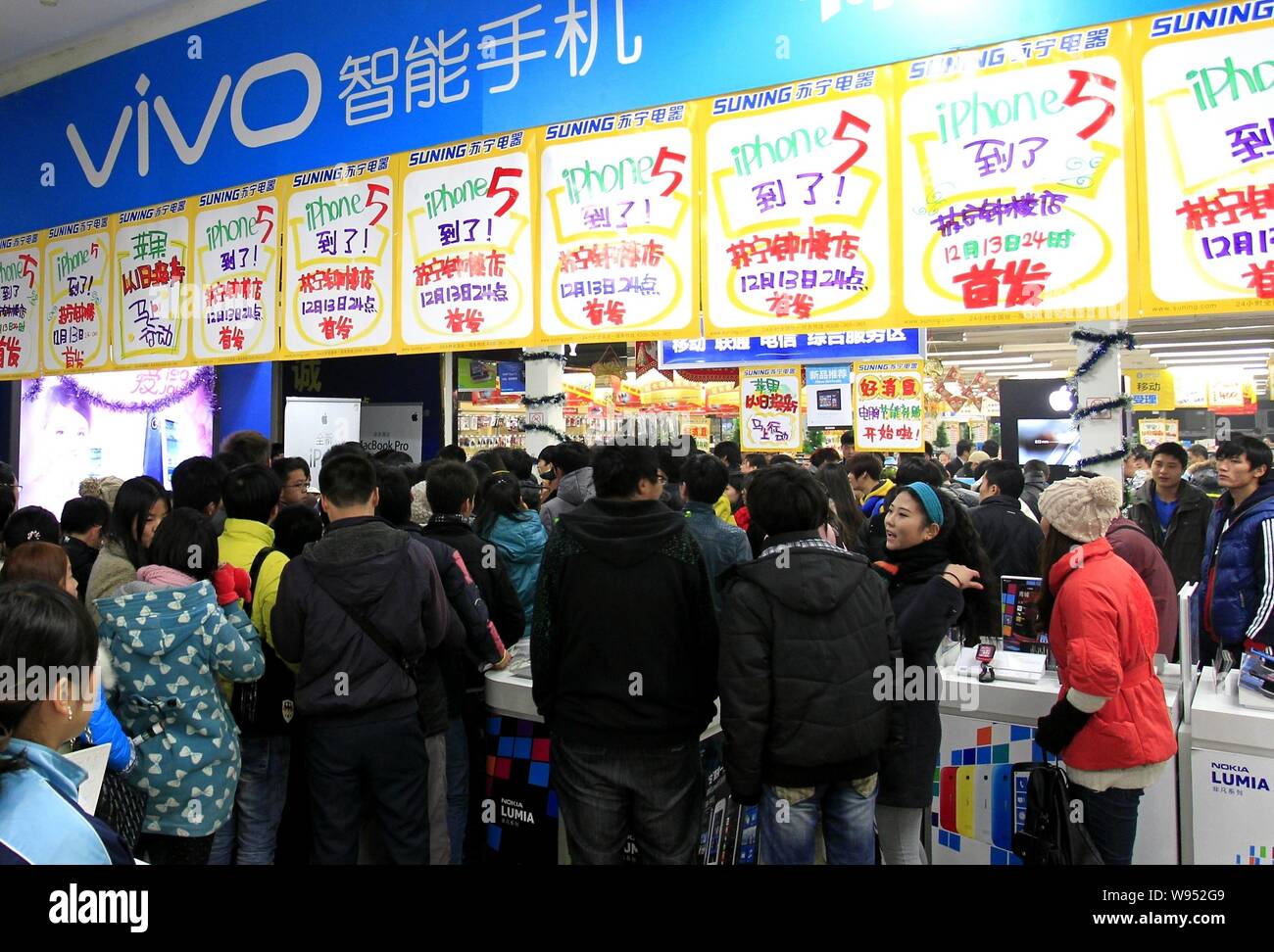 Los clientes chinos se alinean en una tienda para comprar Apple iPhone 5 smartphones en la ciudad de Xian, en el noroeste de la provincia de Shaanxi, China el 14 de diciembre de 2012. La China Foto de stock