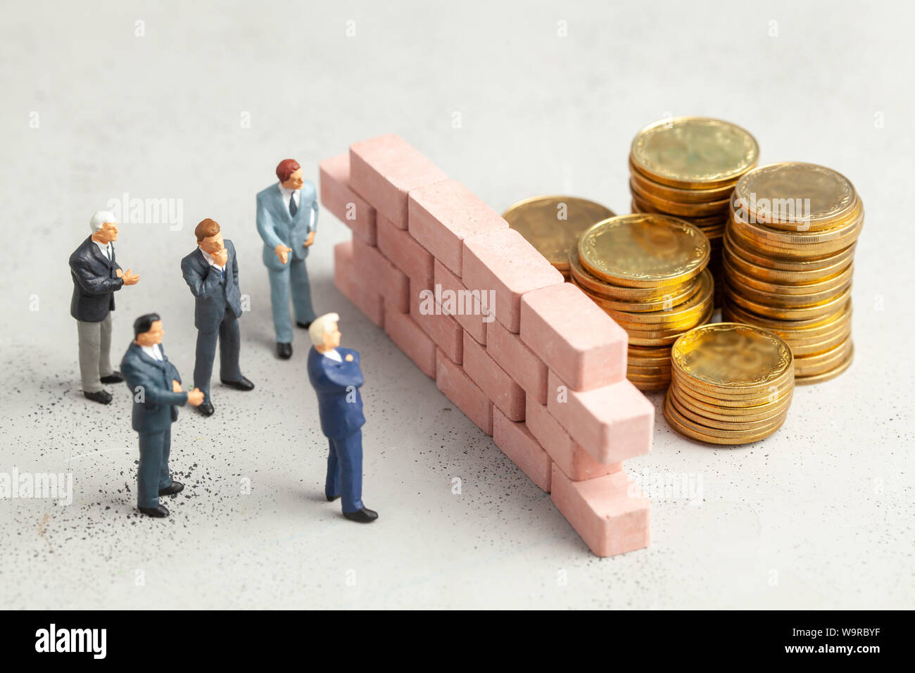 En el camino hacia el objetivo de big money empresario un gran muro como símbolo de problemas o tareas para resolver Foto de stock