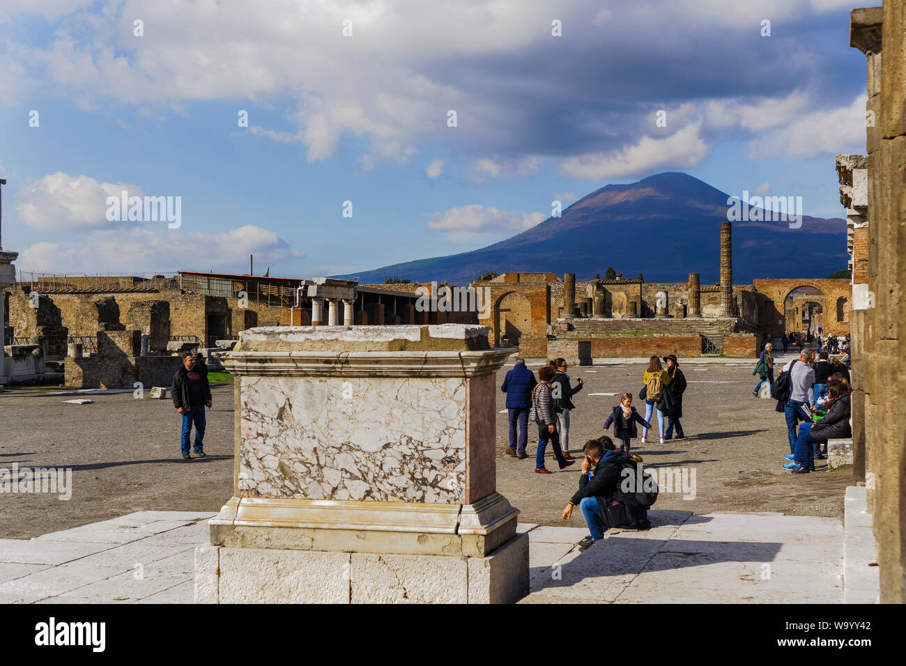 Pompeya, Italia Foro di Pompeya con el Vesubio de fondo. Foro de Pompeya con los visitantes antes de restos arqueológicos del Templo de Júpiter. Foto de stock