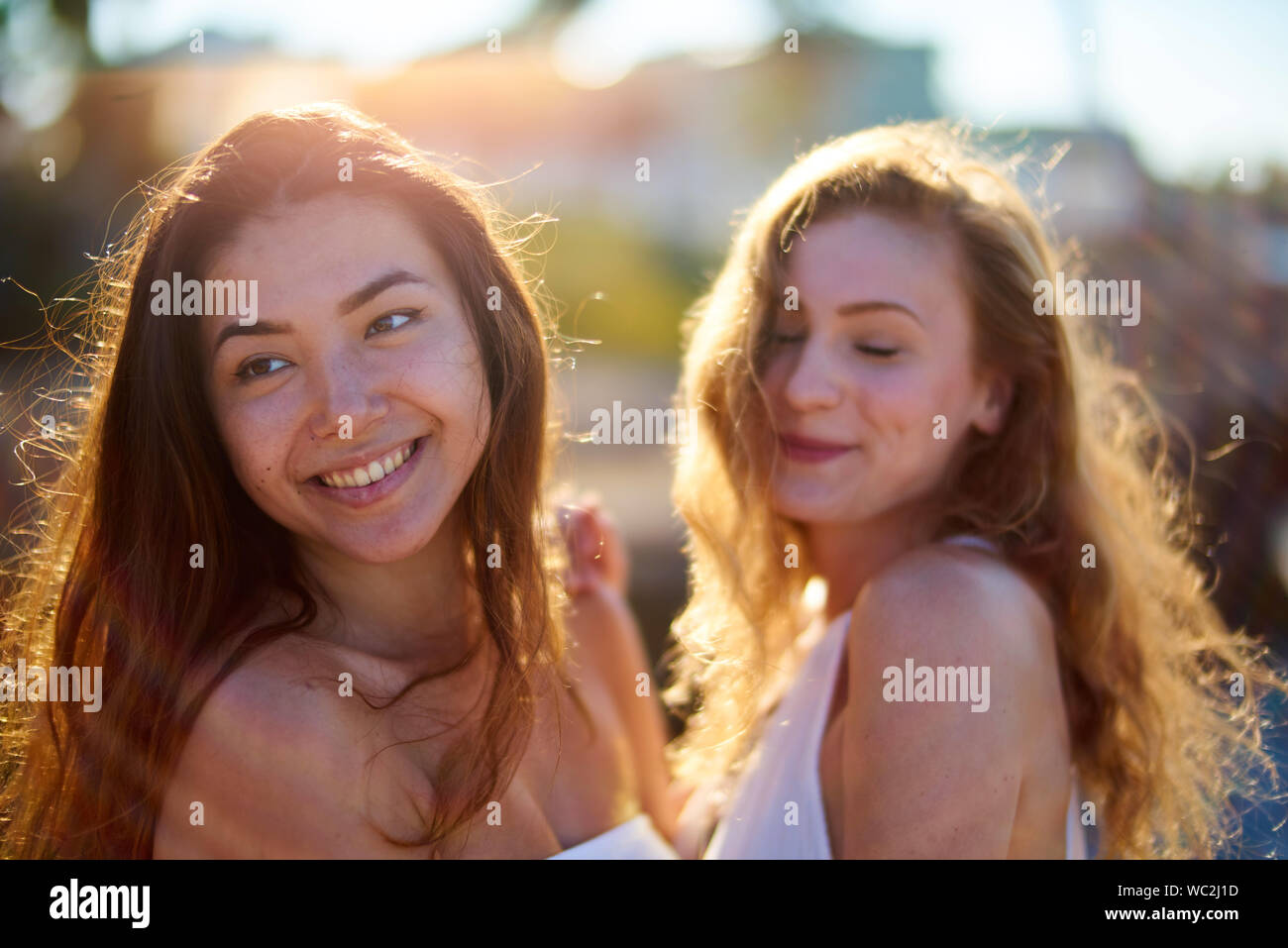 Sonriente joven amigas con el pelo largo Foto de stock