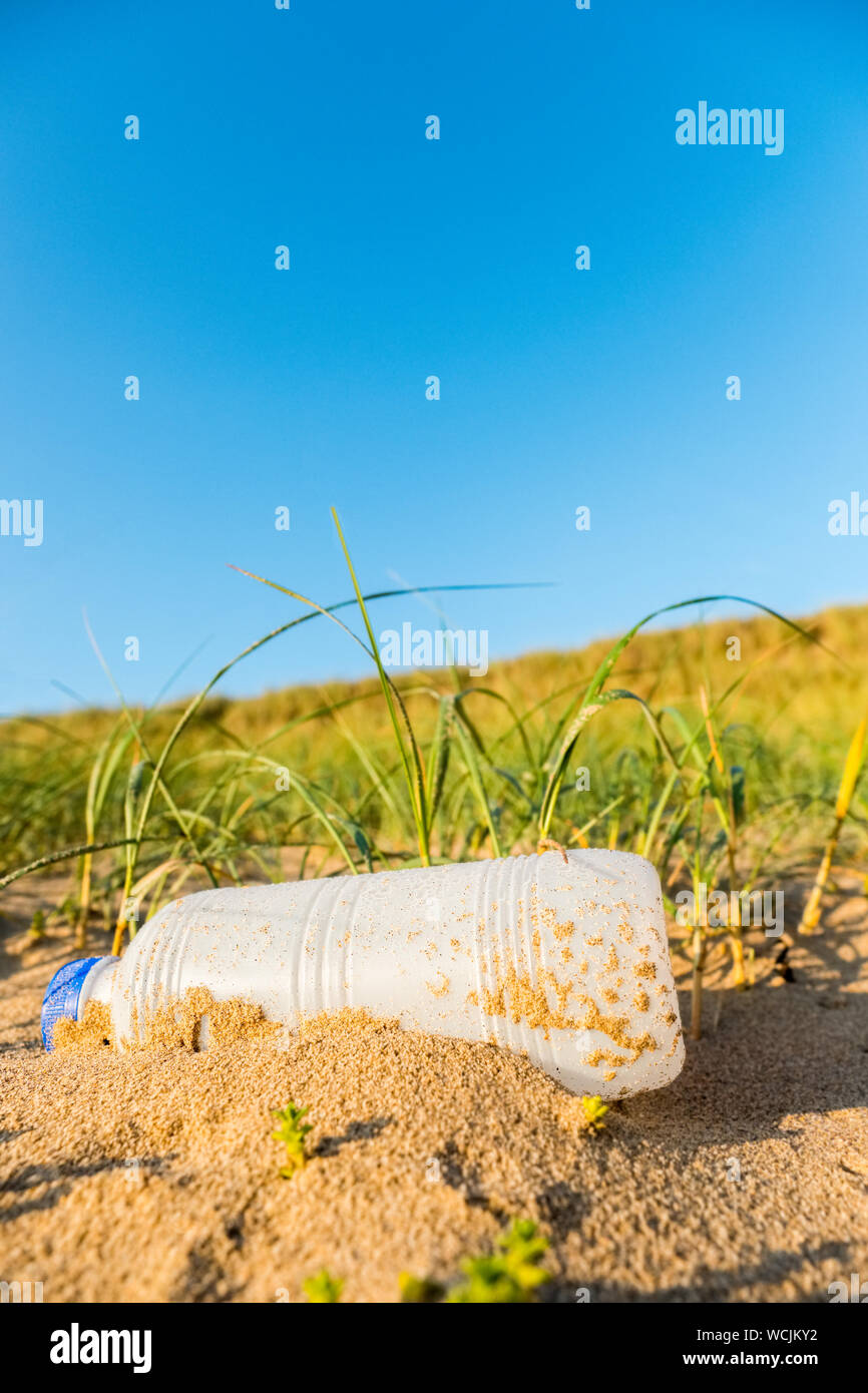 Los residuos plásticos (una botella plástica) contaminación en una playa de Gales UK Foto de stock