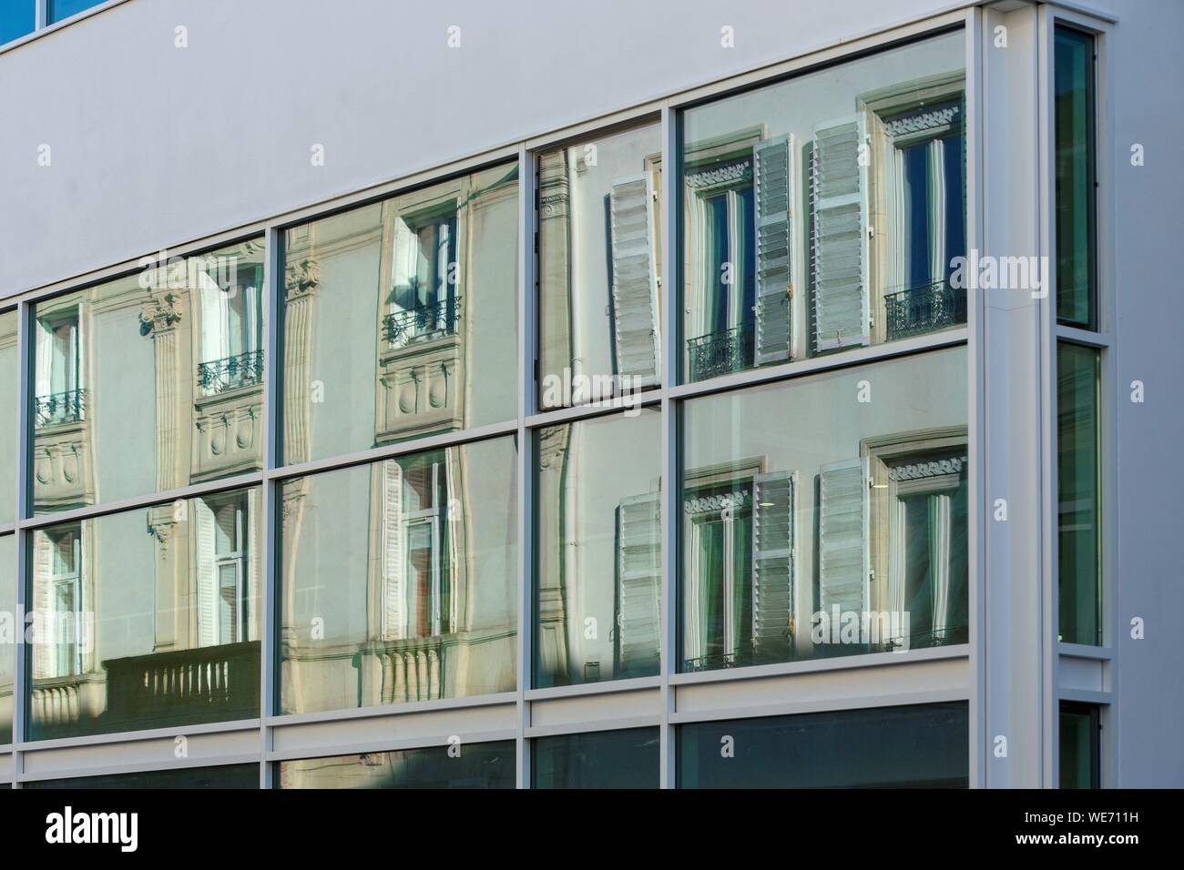 Francia, Meurthe et Moselle, Nancy, reflejo de casas en Rue Desilles sobre el cristal de la ventanilla de un edificio moderno. Foto de stock