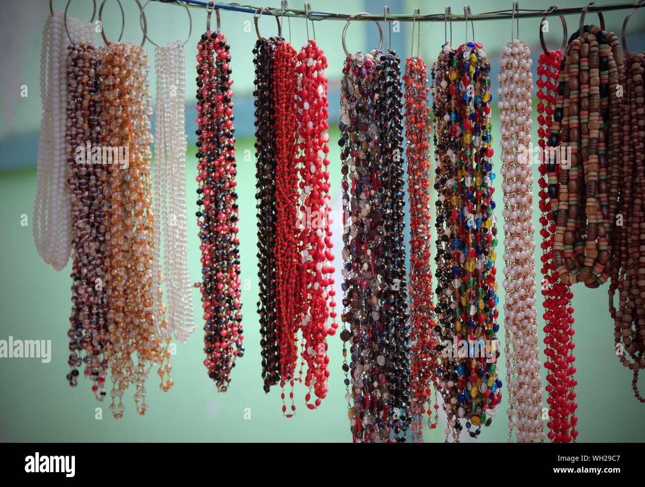 Coloridos Collares abalorios colgando para la venta en el mercado  Fotografía de stock - Alamy