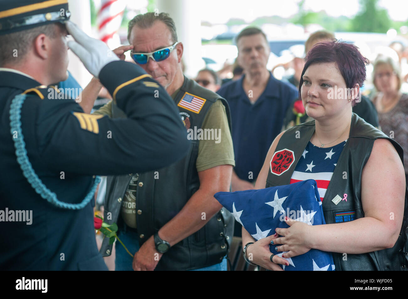 El Sgt. Thomas Morris (a la izquierda) de la Pennsylvania las honras fúnebres militares Programa saluda tras presentar la bandera americana que tapaba la urna Foto de stock