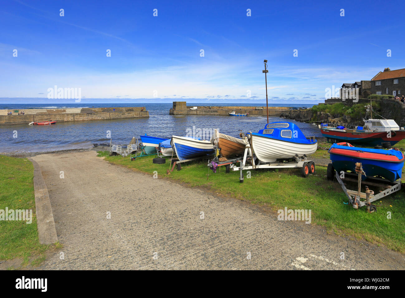 Pequeños barcos de pesca sobre la grada en Puerto Craster, Craster, Northumberland, Inglaterra, Reino Unido Foto de stock