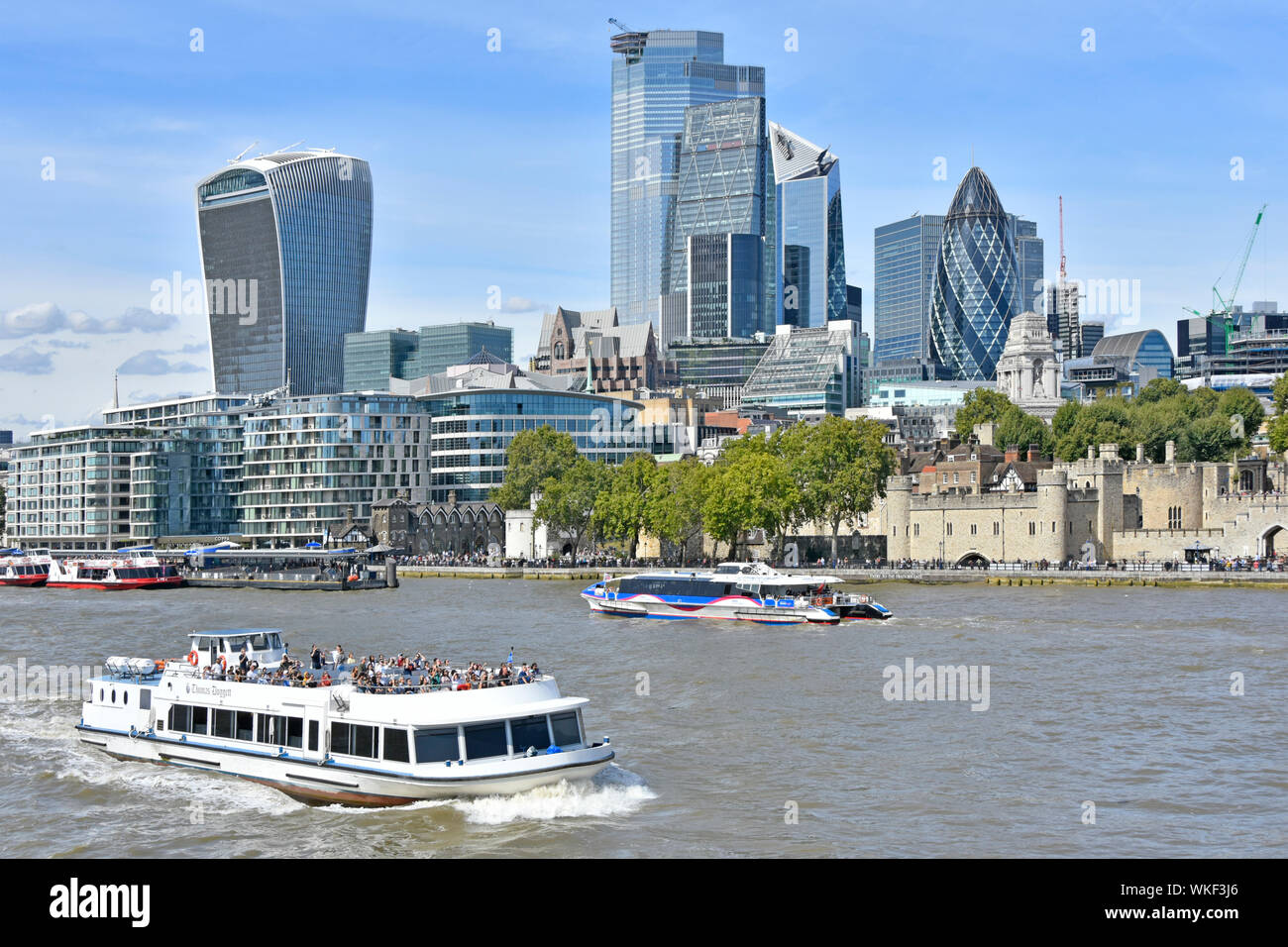 River Thames Clipper catamarán azul & City de Londres ciudad rascacielos landmark edificios en City Square Mile distrito financiero Inglaterra Foto de stock