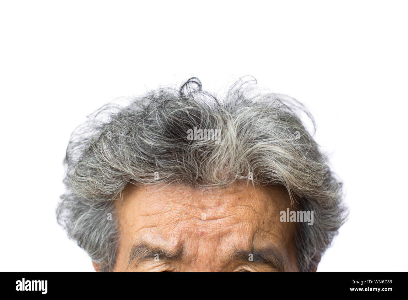 Imagen recortada del hombre con cabello gris contra el fondo blanco. Foto de stock