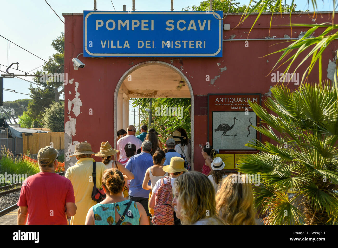 Pompeya, cerca de Nápoles, Italia - Agosto 2019: Personas en cola para salir de la estación de Pompeii Scavi. La estación está al lado del sitio de la ruina histórica Foto de stock