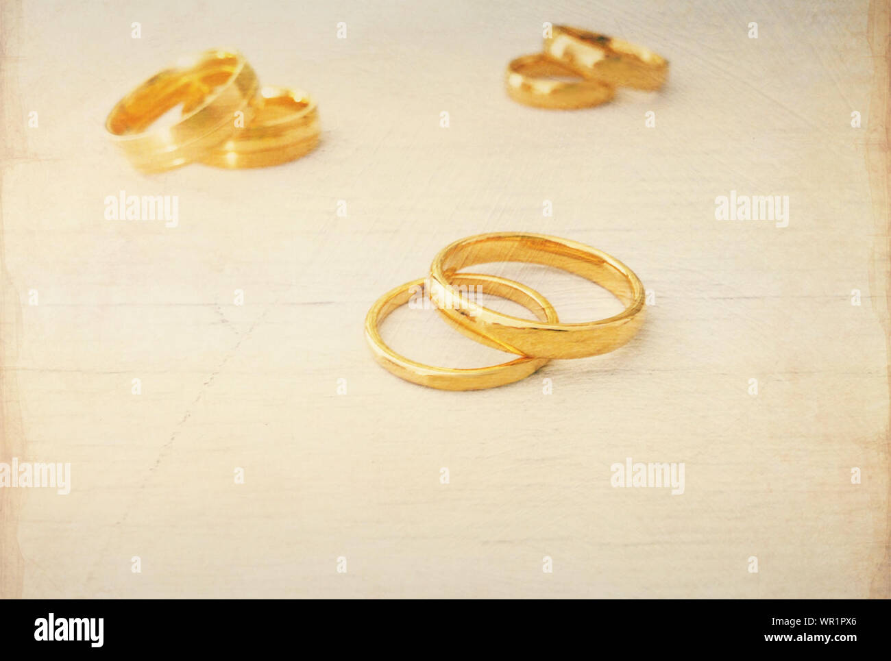 Pares de anillos de boda de oro sobre la mesa de madera Foto de stock