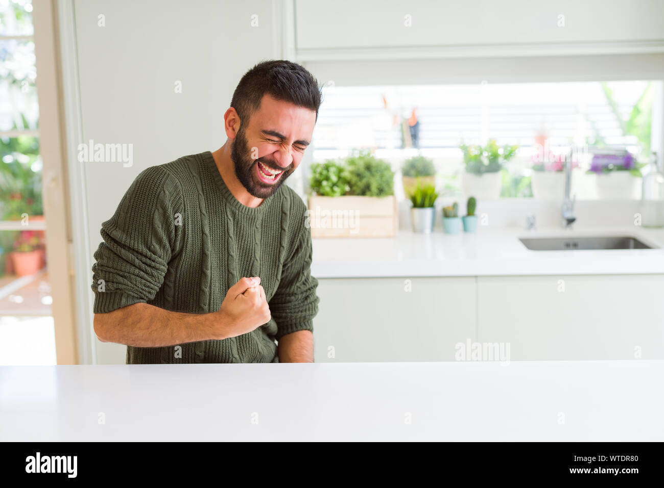 Guapo celebrando y aplaudiendo con entusiasmo, expresión, smilling para ganar éxito Foto de stock