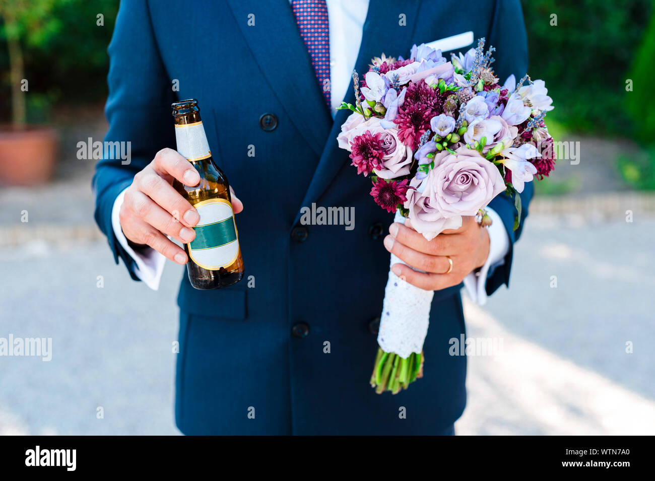 El novio sosteniendo un ramo de novia y Cogiendo una cerveza Fotografía de  stock - Alamy