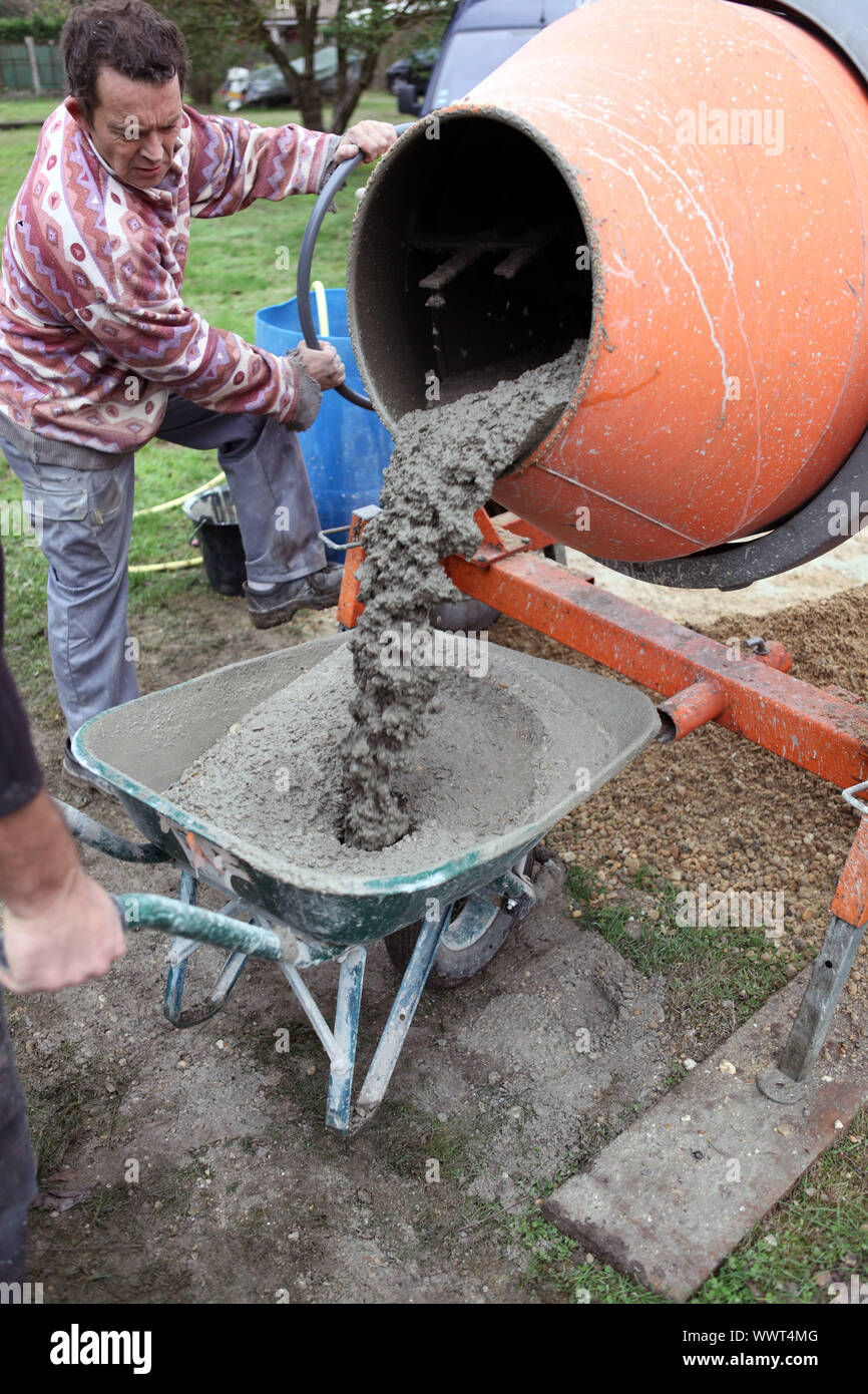 Hombre con una mezcladora de cemento Fotografía de stock - Alamy