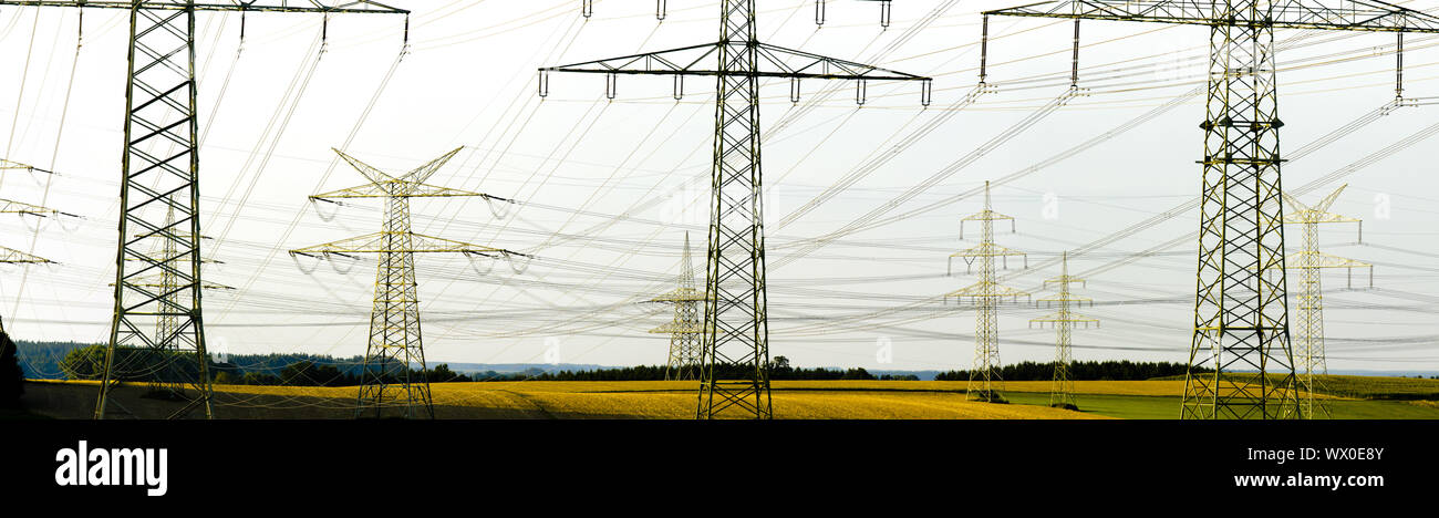 Muchas torres de energía de una línea de alta tensión Foto de stock