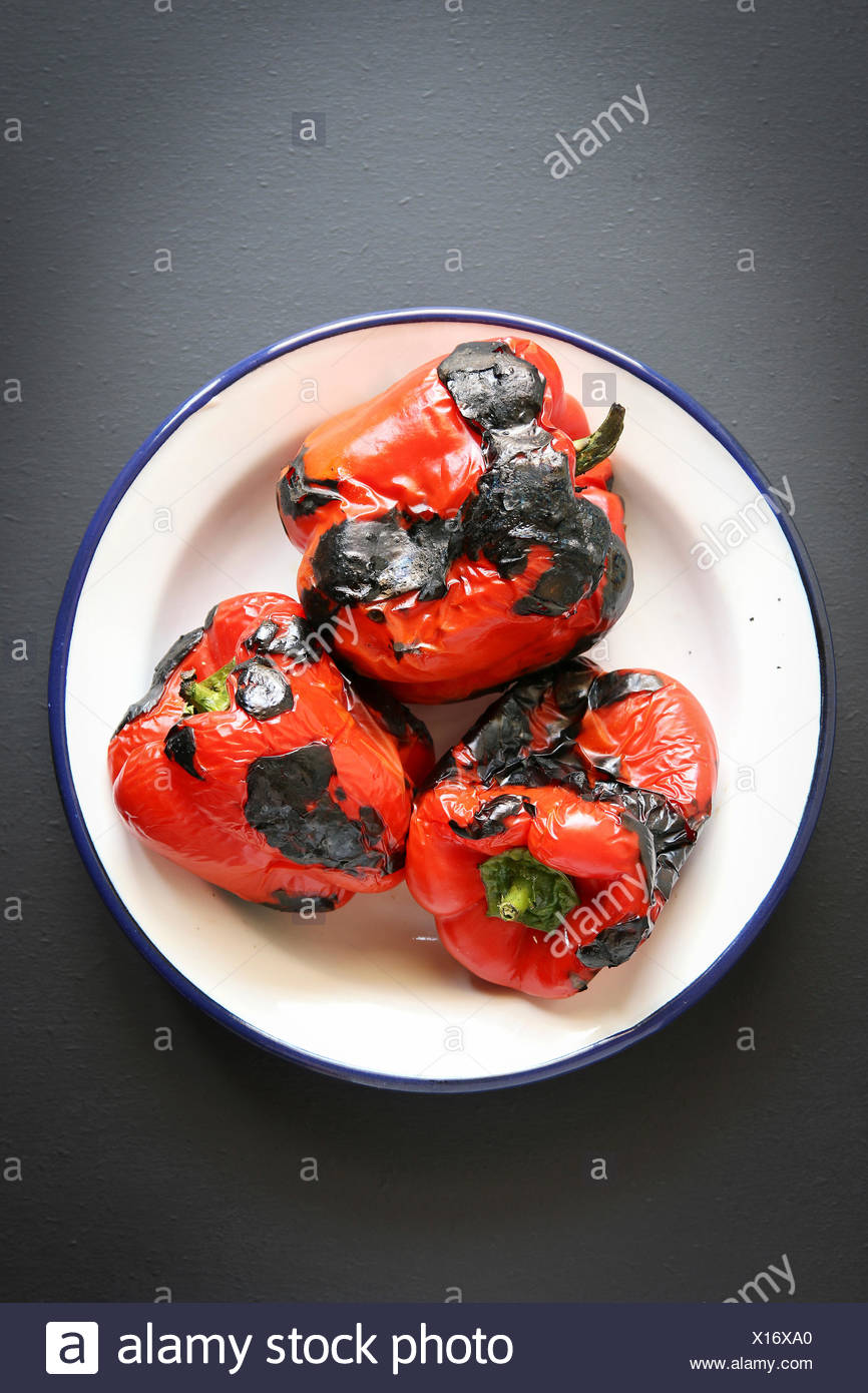 3 pimiento rojo asado sobre una placa de esmalte.vista superior Foto de stock