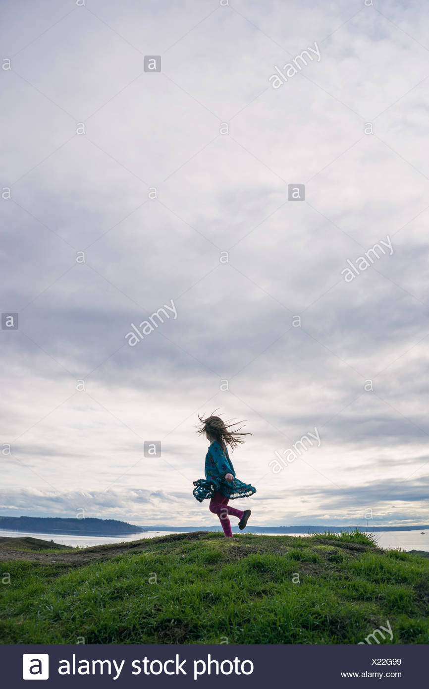 Chica girando en torno a una colina Foto de stock