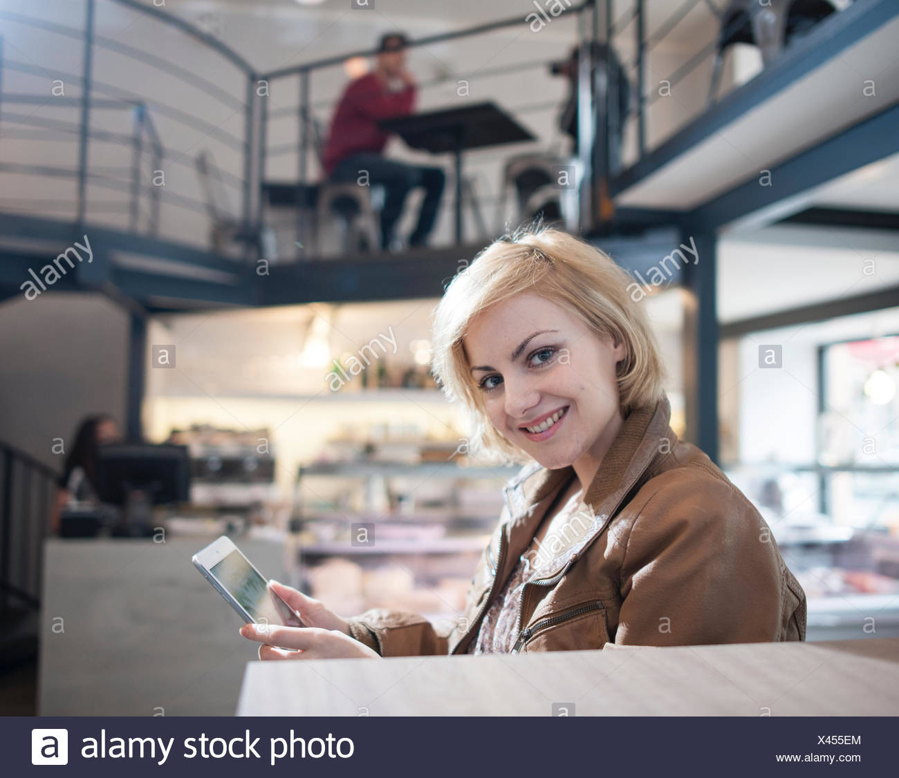 Retrato de mujer sonriente con tablet PC en cafe Foto de stock