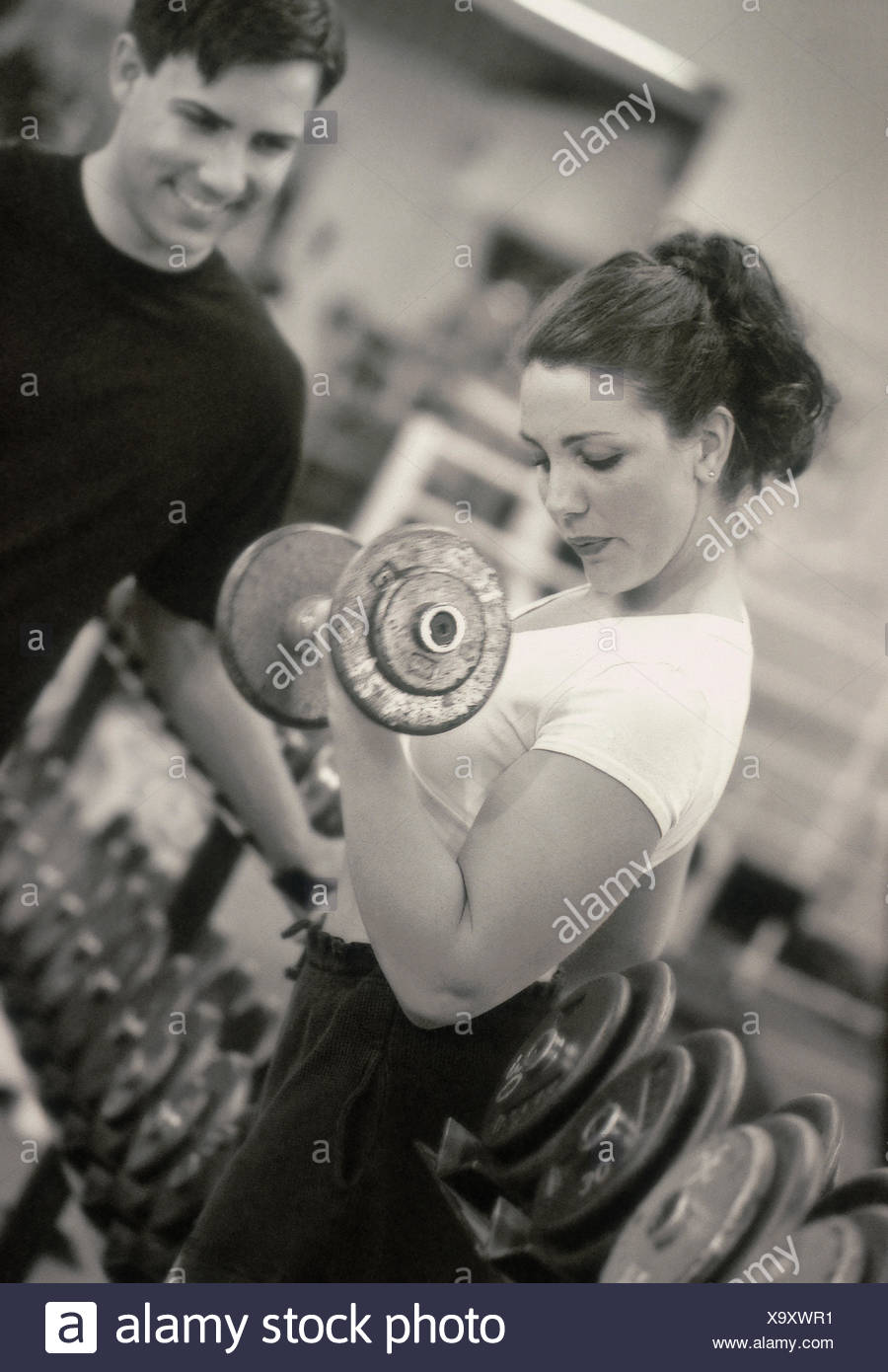 Macho y hembra caucásica levantamiento de pesas en el gimnasio (Modelo liberado) Foto de stock