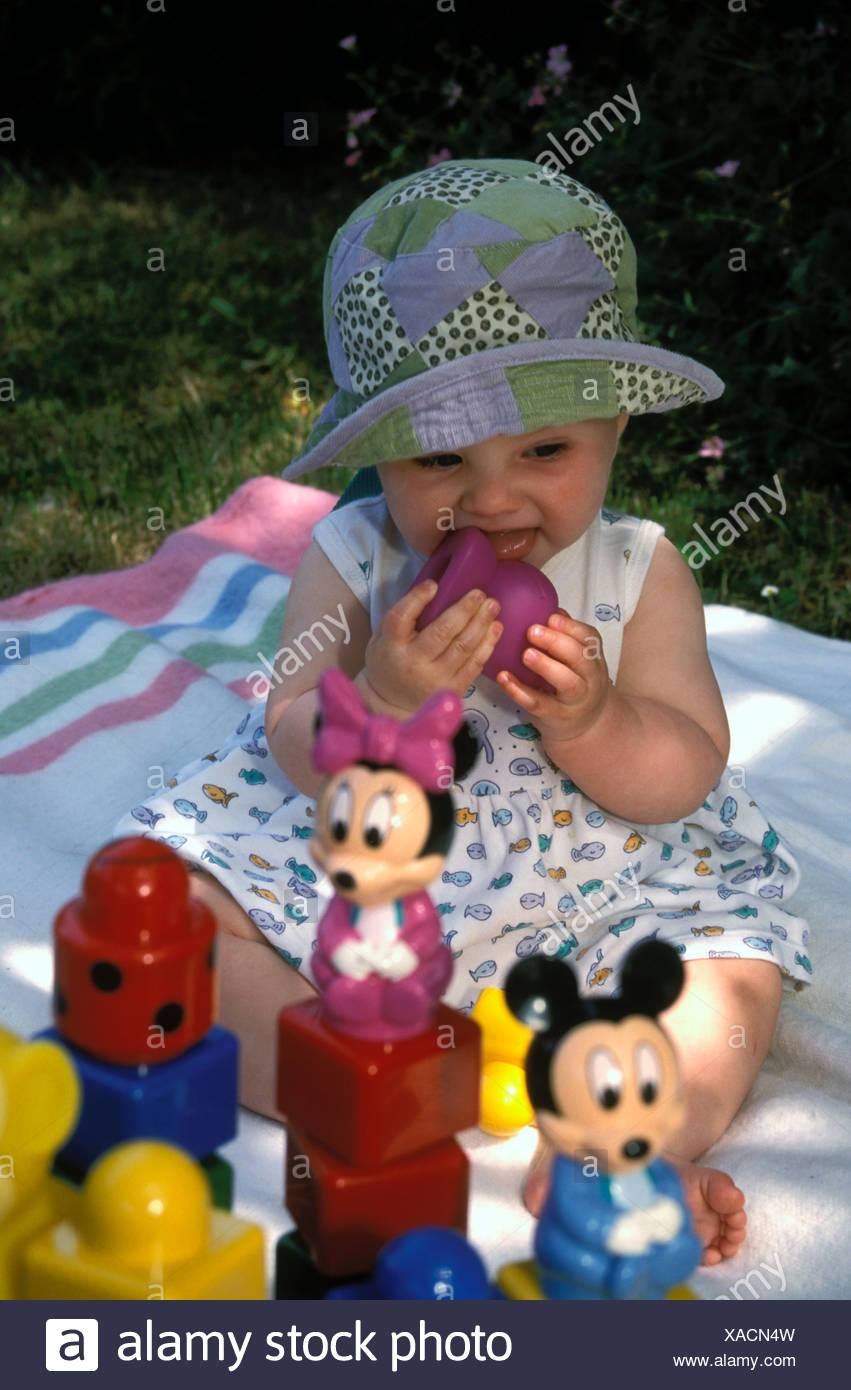 Niña de 9 meses el bebé niña jugando con sus juguetes de chupar un juguete de plástico rosa UK Fotografía de stock - Alamy