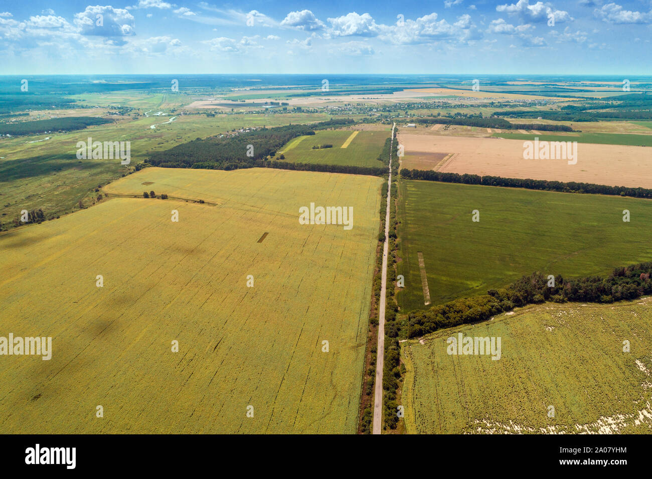 La route à travers champs arables et beau ciel pittoresque. Vue de dessus de la campagne et l'autoroute. Paysage rural de l'été sur une journée ensoleillée Banque D'Images