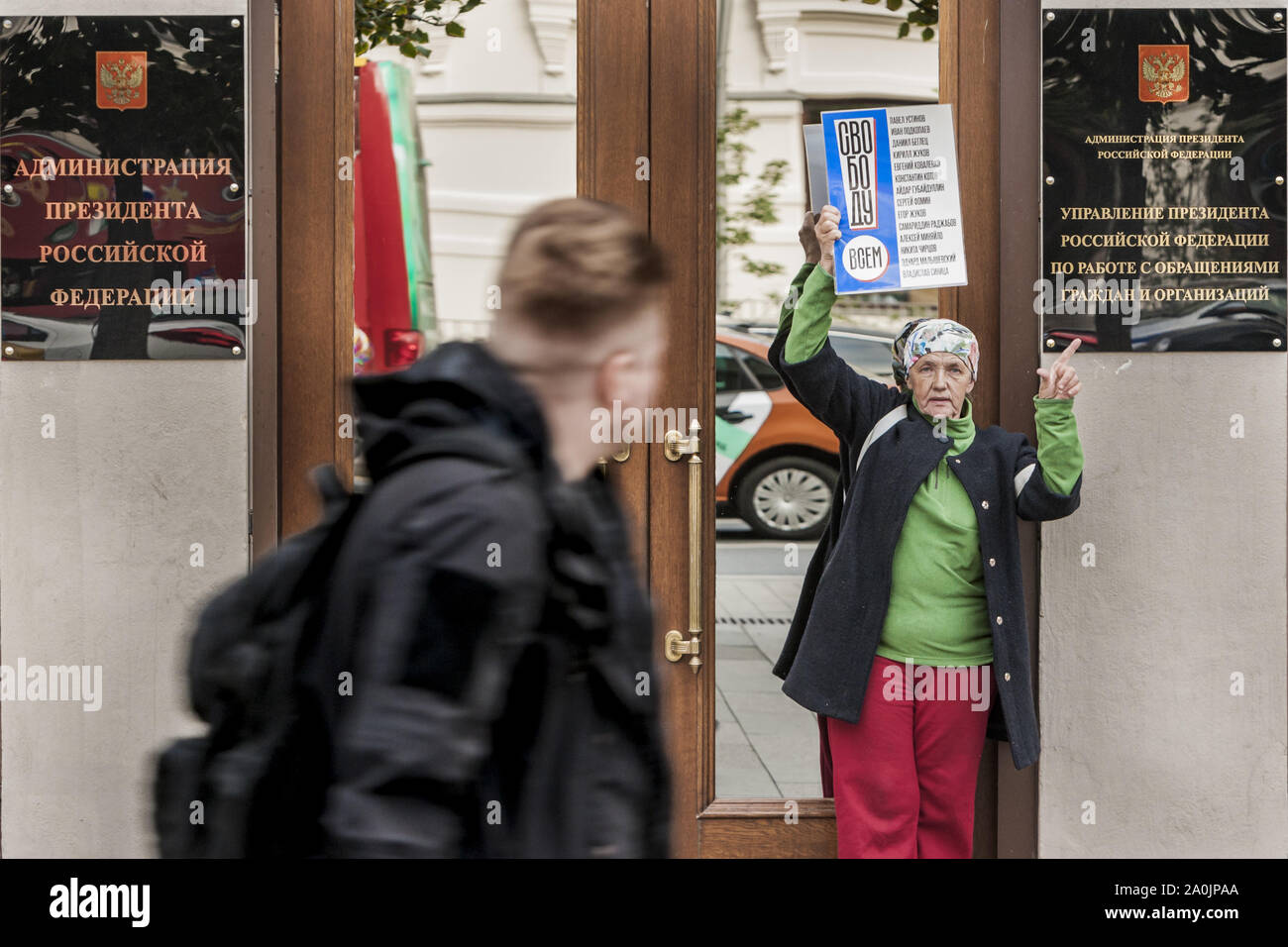 Moscou, Russie. Sep 20, 2019. Un homme regarde un manifestant tenant une bannière pour la libération des activistes arrêtés dans les manifestations de l'opposition pendant la campagne des élections locales à Moscou. Bannière représente les noms des militants arrêtés. Stand des piquets à l'entrée du Président de l'Administration. Credit : Celestino Arce Lavin/ZUMA/Alamy Fil Live News Banque D'Images