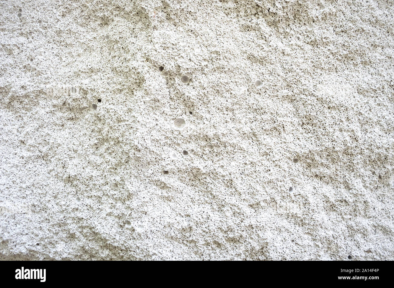 Fond blanc mur de béton poreux. La texture du mur en pointillés Banque D'Images