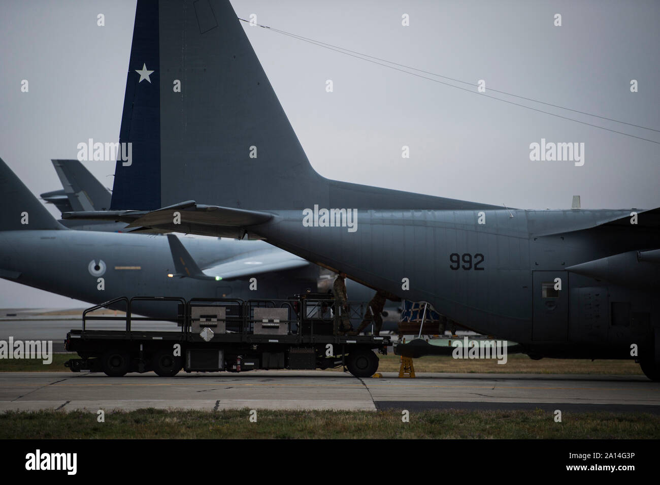 Les aviateurs de l'US Air Force pousser une palette de marchandises sur un chargeur sur un cargo de l'Armée de l'air chilienne Hercules C-130, en préparation d'une mission de largage sur Beller zone de chute pendant l'exercice 2019, Guardian Mobility Fairchild Air Force Base, Washington, 23 septembre 2019. La mobilité de l'exercice est gardien de l'Air Mobility Command, premier exercice de la mobilité à grande échelle. La participation des partenaires internationaux dans le domaine de la mobilité d'un tuteur est indispensable à l'amélioration des partenariats nécessaires pour fournir rapidement à la mobilité mondiale. Au total, 29 partenaires participent à l'exercice. (U.S. Air Force photo de Tech. Le Sgt. Larry E. Reid Jr. Banque D'Images