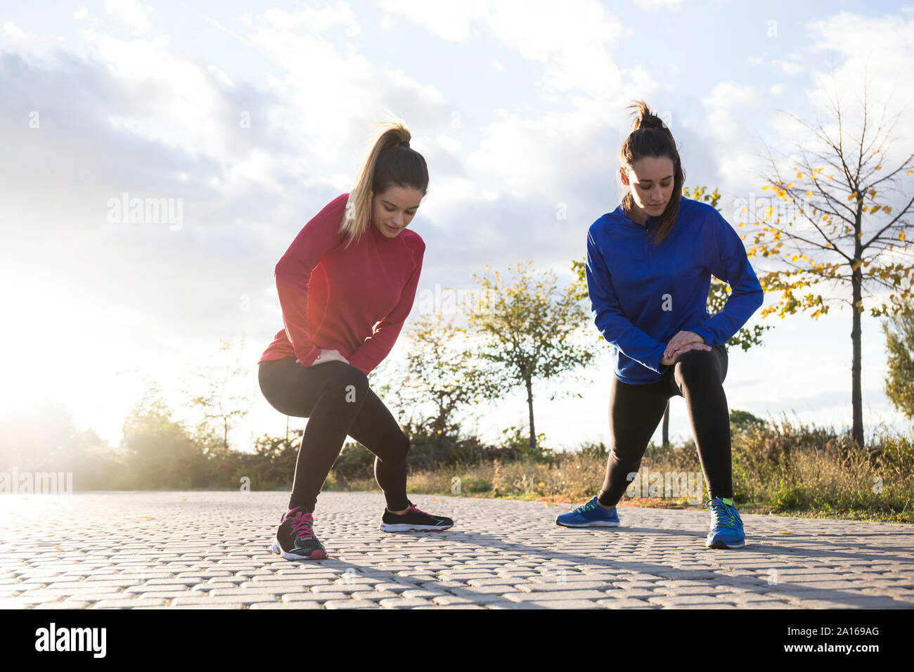 Les femmes s'étend ses jambes dans le parc Banque D'Images