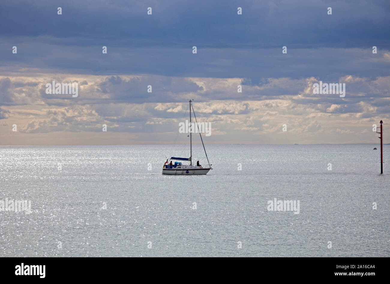 Yacht à voile à la position dans la baie ouest, vue de la plage d'East Cliff, Bridport, Dorset, England, UK Banque D'Images