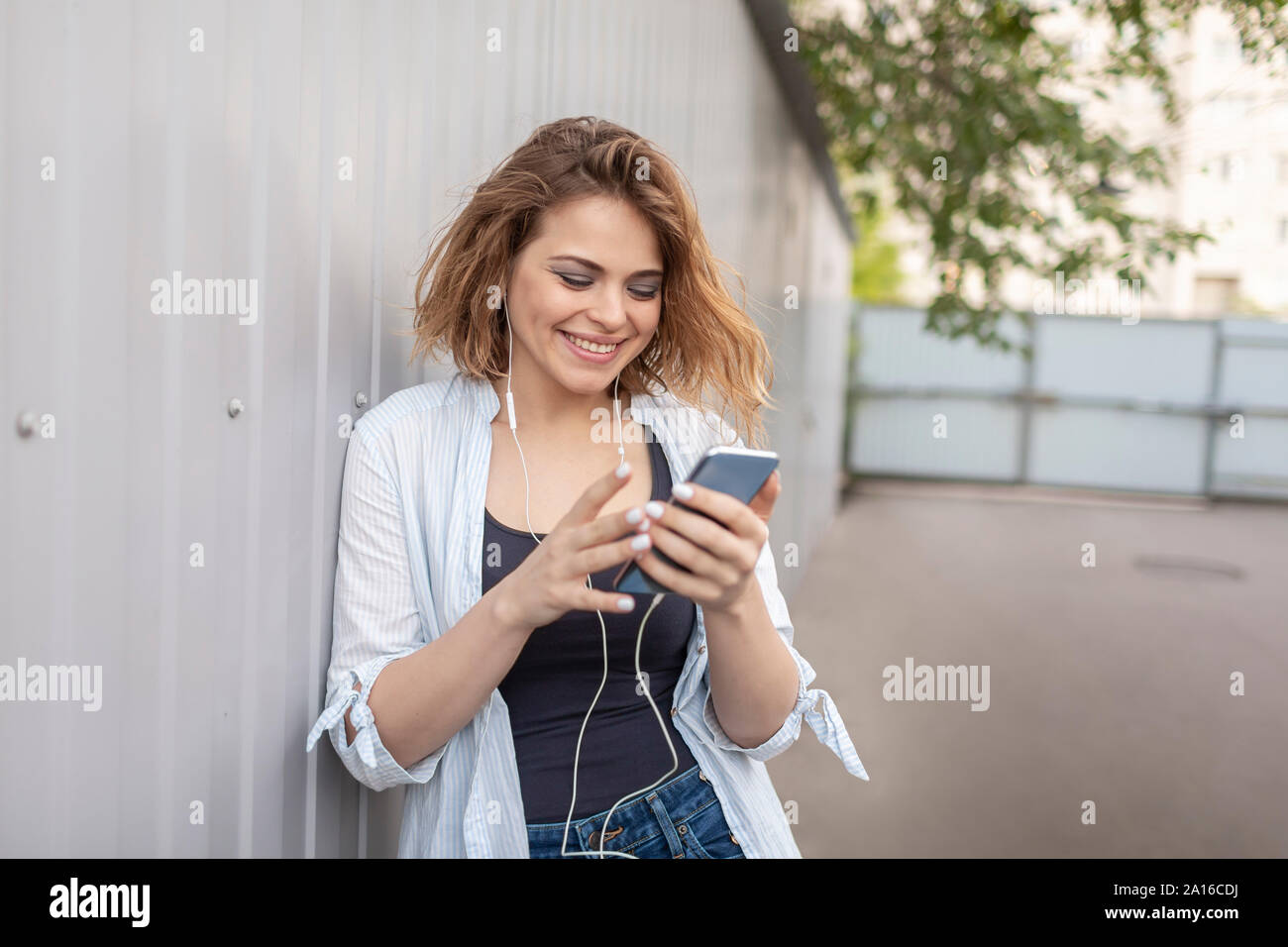East European woman using smartphone Banque D'Images