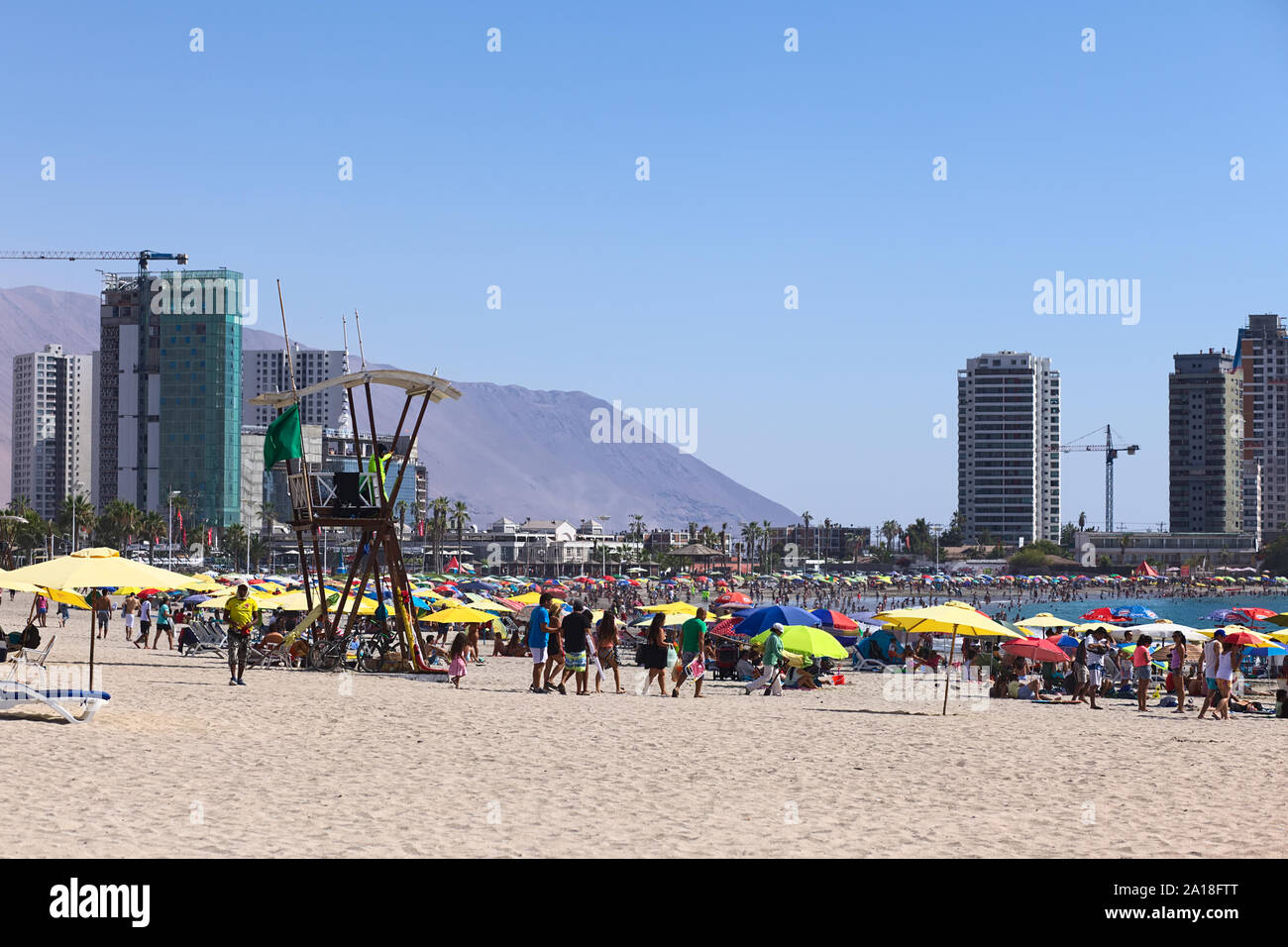 IQUIQUE, CHILI - 23 janvier 2015 : tour de sauveteur, de parasols et de nombreux visiteurs sur Cavancha Beach le 23 janvier 2015 à Iquique, Chili Banque D'Images