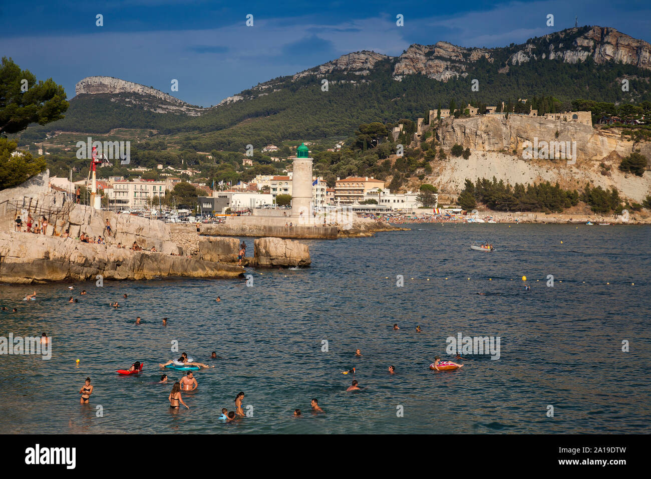 La natation de personnes sur la plage, plage Le Bestouan, dans l'arrière-plan le phare de Cassis, Bouches-du-Rhône, Provence-Alpes-Côte d'Azur, le sud de Fr Banque D'Images
