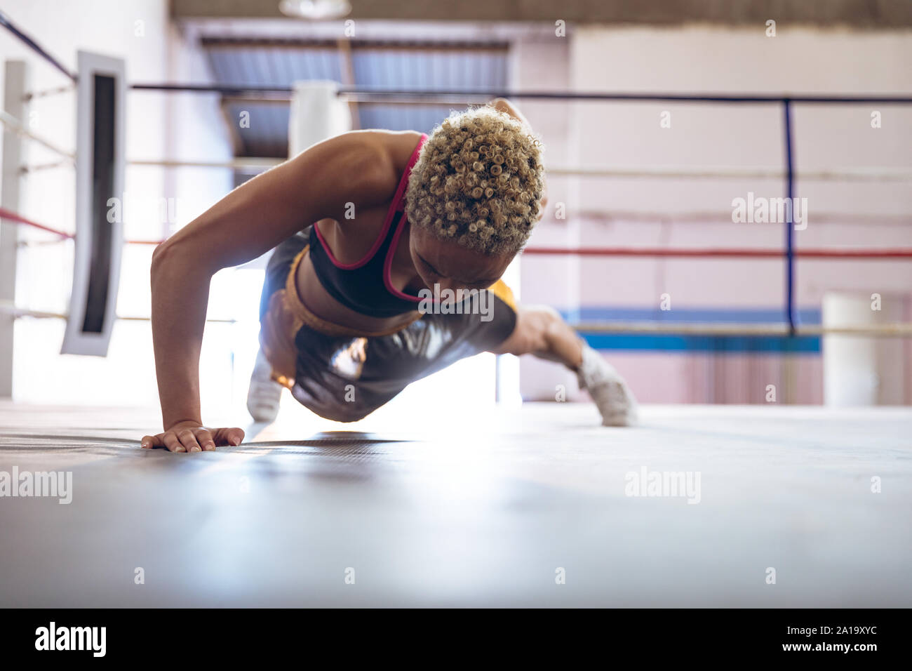 Boxer exerçant en ring de boxe au centre de remise en forme Banque D'Images