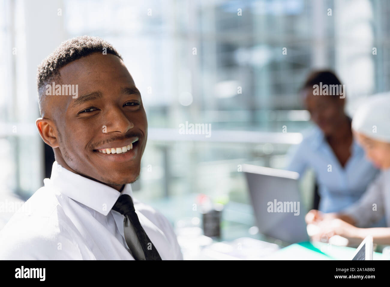 Happy Businessman sitting at desk in office Banque D'Images